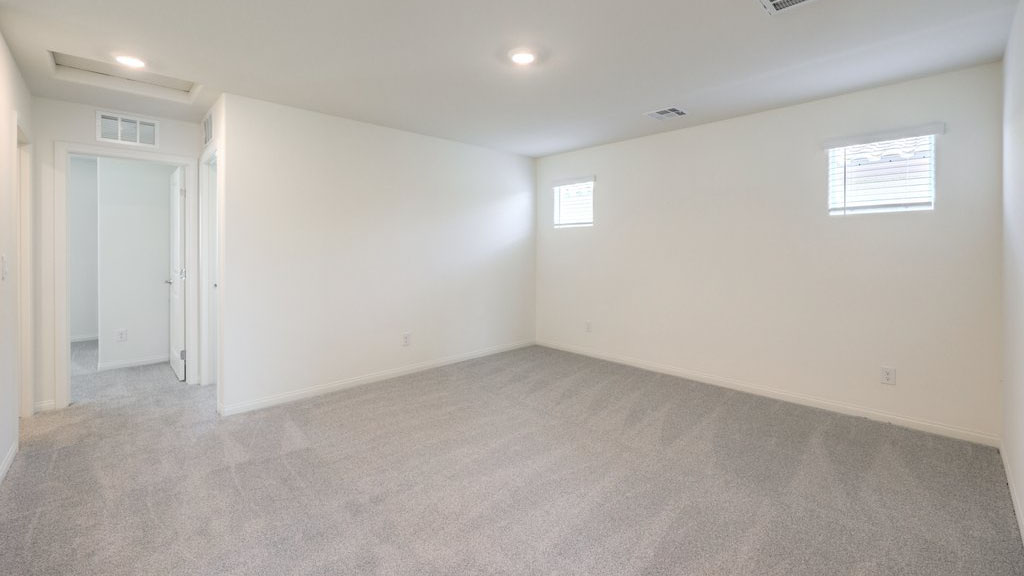 The upstairs loft in our Symmetry Bay 1715 model with carpet flooring and a closet.