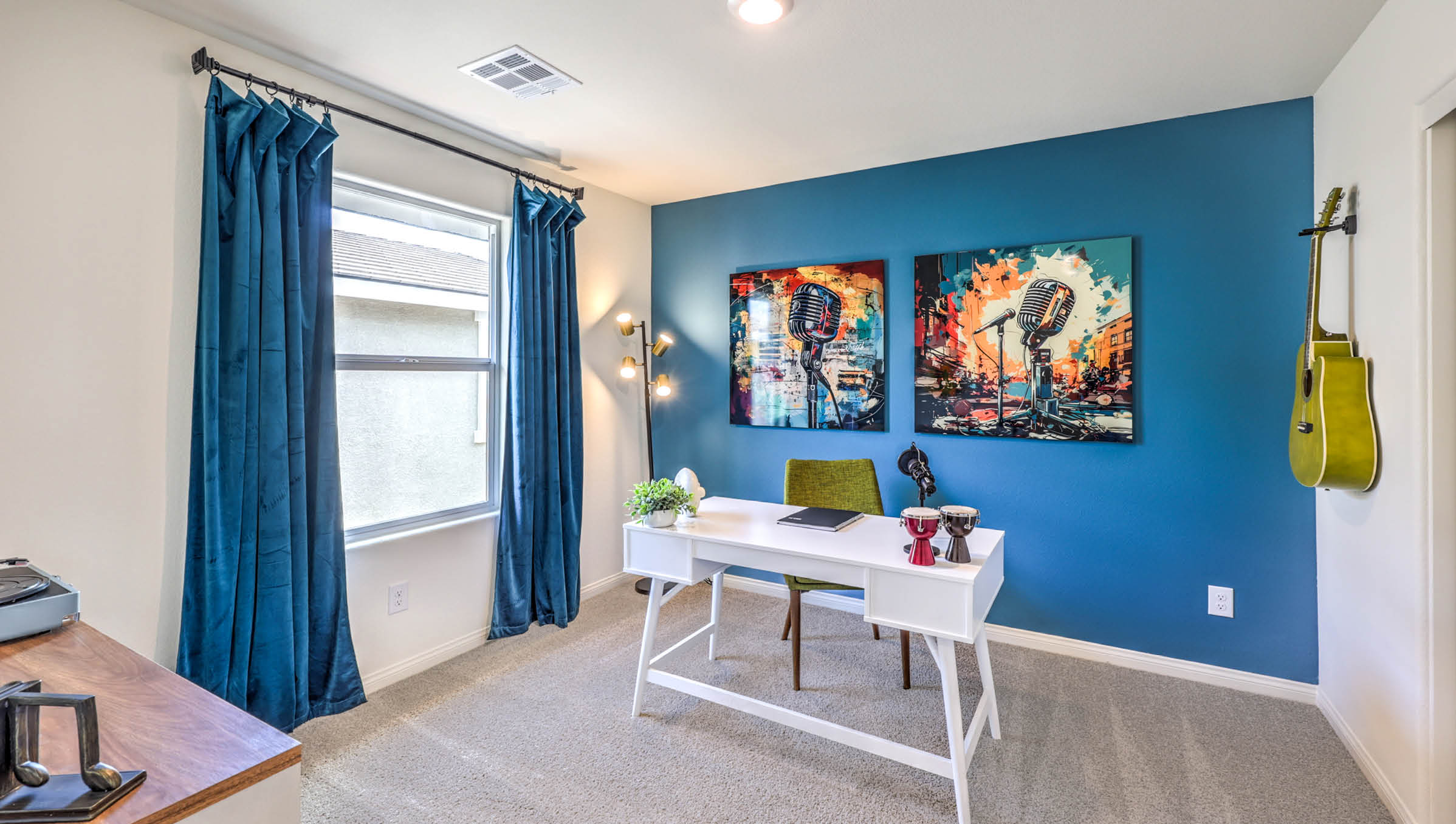 The Office/Bedroom Three option in our Symmetry Bay 1802 model with carpet flooring, a sliding closet, and a window, furnished with a desk and chair.