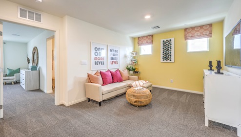 At the top of the stairs, the loft in our Symmetry Bay 1865 plan with carpet flooring.