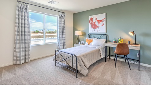 The Symmetry Falls 3000 Model Second Bedroom with plush wall-to-wall carpet, large window for natural light, and a spacious layout designed for comfort. This secondary bedroom offers a quiet retreat with easy access to a nearby full bathroom, making it ideal for family members or guests.