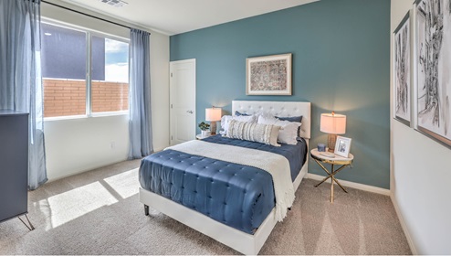 The Symmetry Falls 3000 Model Second Bedroom with plush wall-to-wall carpet, large window for natural light, and a spacious layout designed for comfort. This secondary bedroom offers a quiet retreat with easy access to a nearby full bathroom, making it ideal for family members or guests.