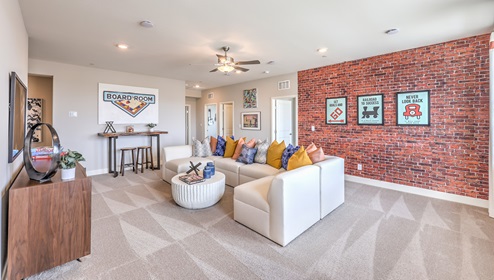 The upstairs loft in our 4425 model with carpet flooring and large windows.