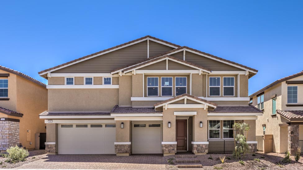 Our 3825 model home in the Symmetry Summit community with tan and white exterior paint schemes, a flat tile roof, front yard landscaping, paver walkways, and a three-car garage.