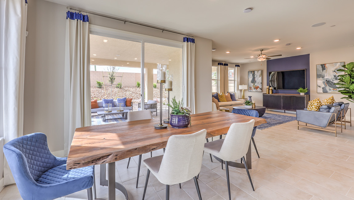The Symmetry Summit 4425 model Dining Room adjacent to the kitchen and great room with a table and sliding door to the backyard.