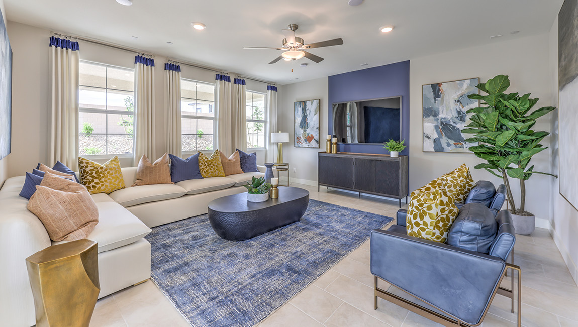 The Symmetry Summit 4425 Plan open concept Great Room with ceramic tile flooring and large windows.