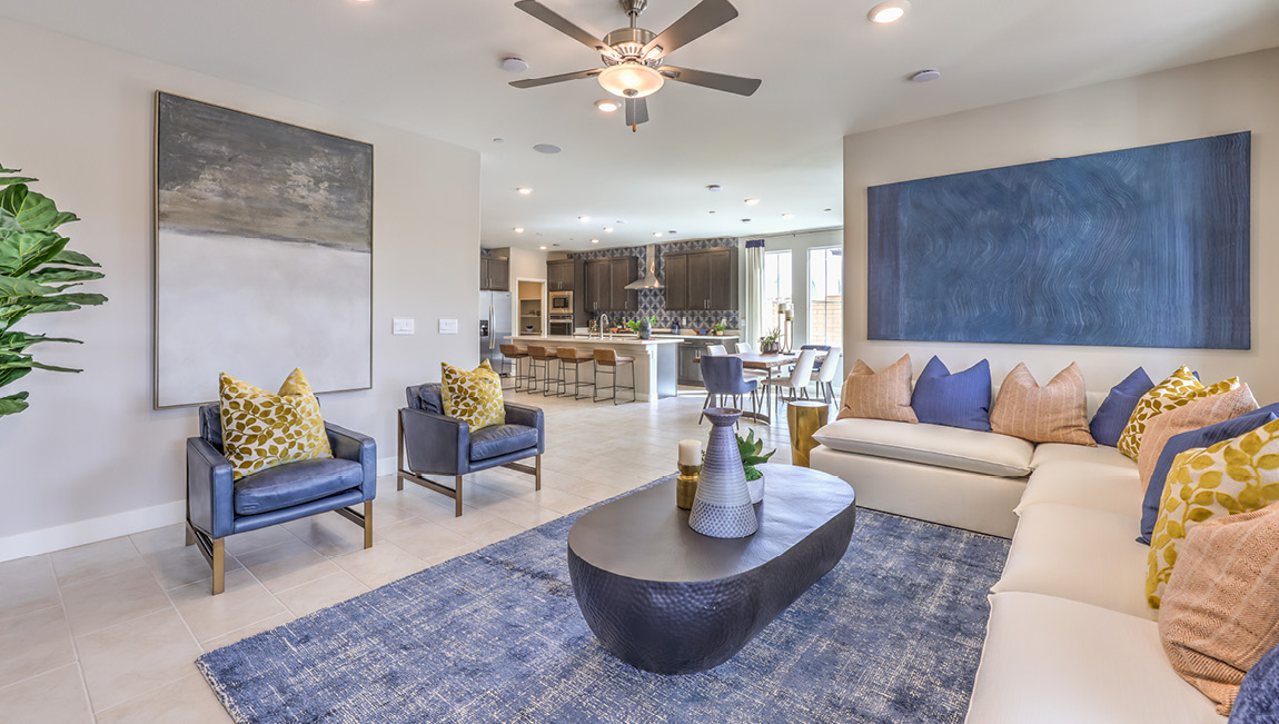 The Symmetry Summit 4425 Plan open concept Great Room with ceramic tile flooring and large windows.