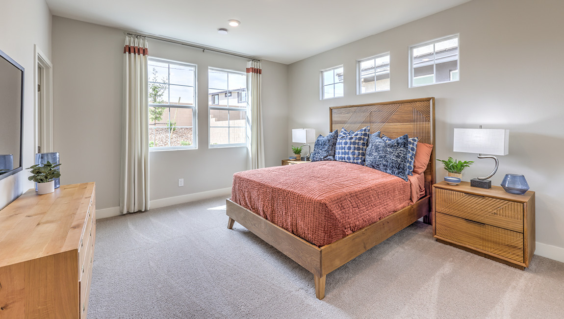Bedroom Six in our Symmetry Summit 4425 Multigen Suite with carpet flooring, a walk-in closet, and five windows.