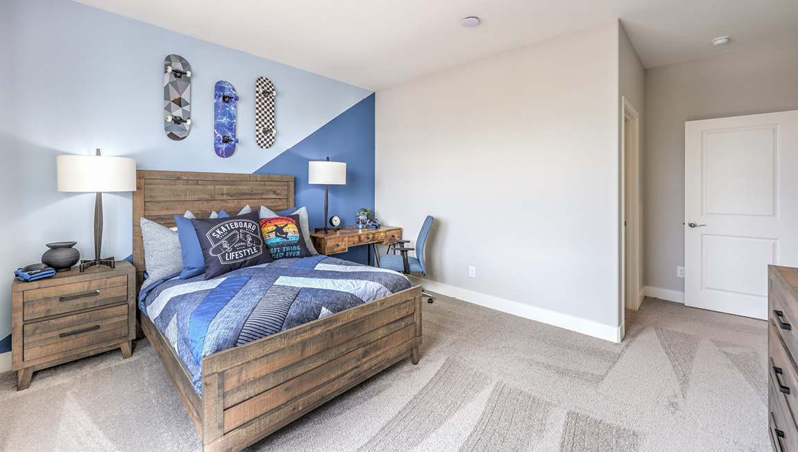 Bedroom Three in our Symmetry Summit 4425 model with carpet flooring, a walk-in closet, and a window.