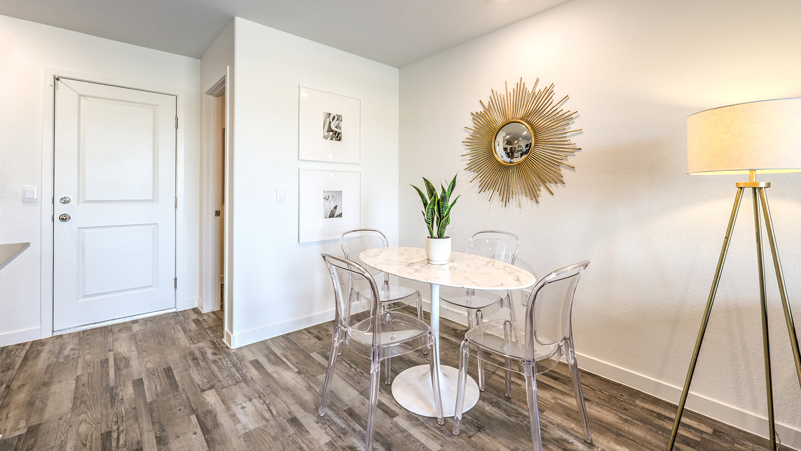 The Symmetry Trails 1309 model Dining Room adjacent to the kitchen with a table.