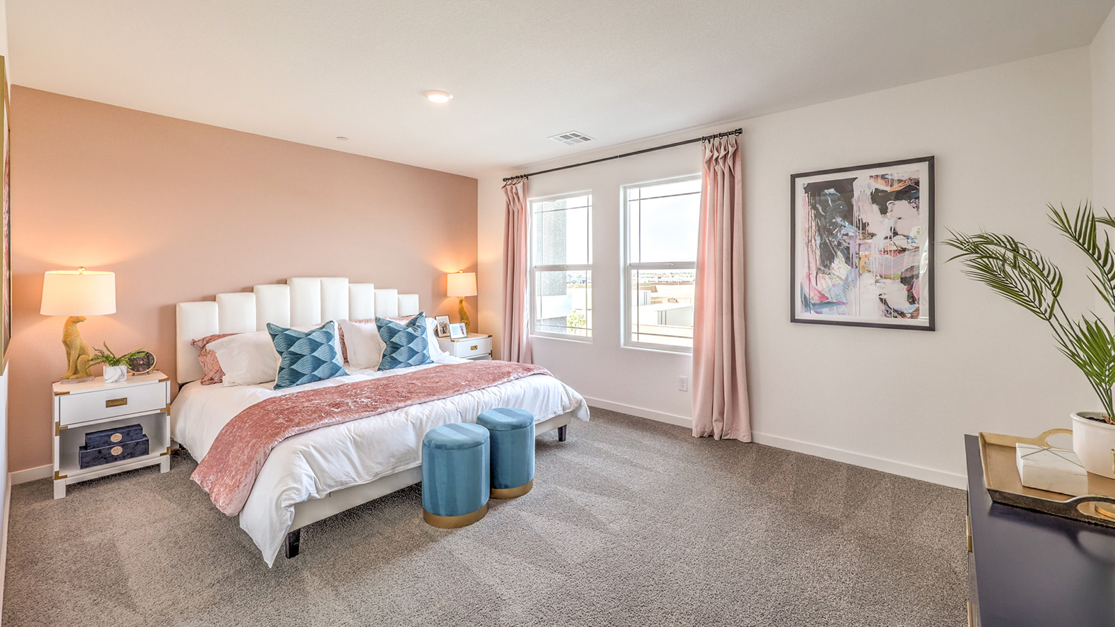 The Bedroom One Suite in our Symmetry Trails 1309 model with carpet flooring, a walk-in closet, windows, and recessed ceiling lights.
