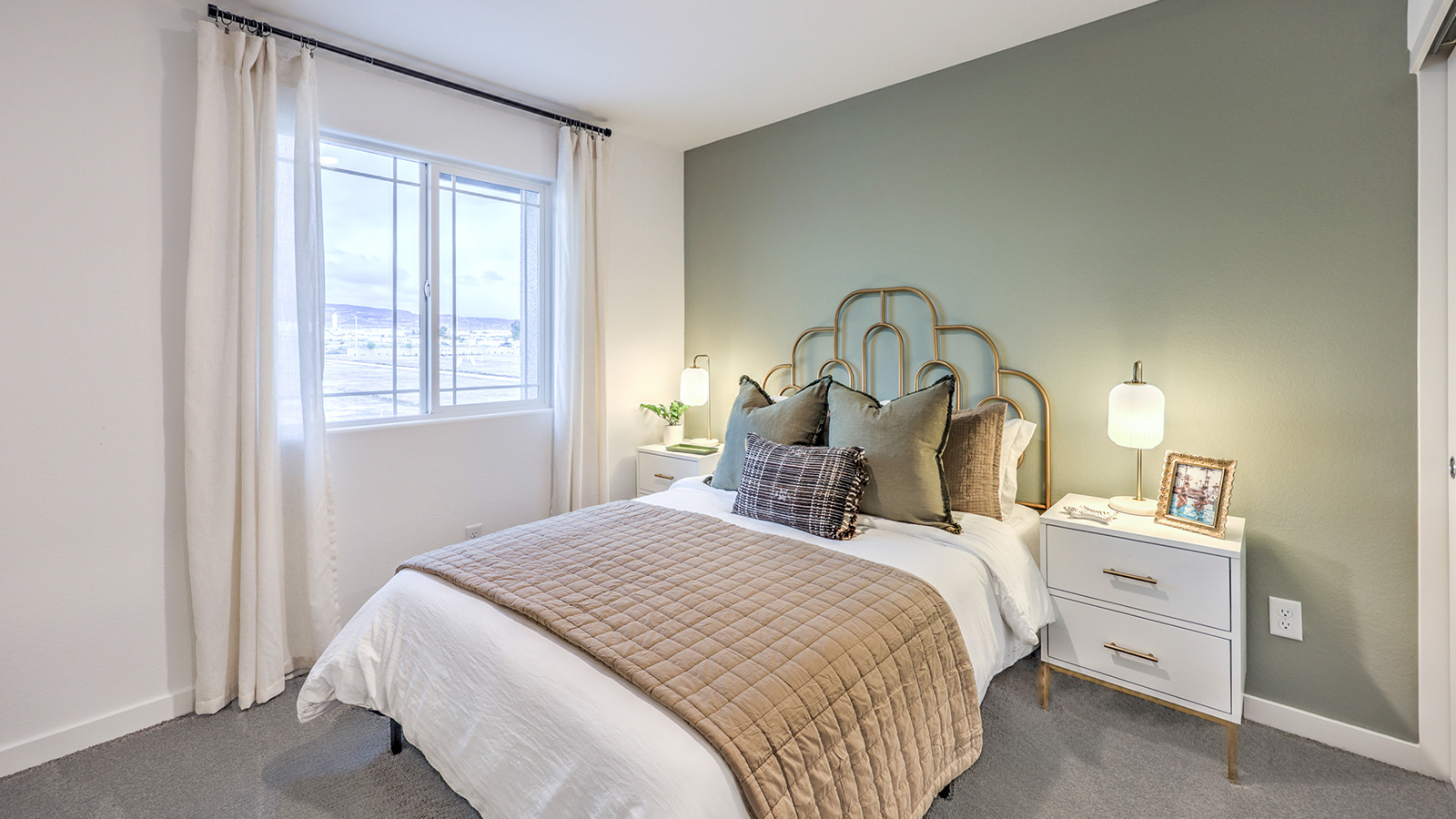 The Office/Bedroom Two option in our Alpine Trails 1309 model with carpet flooring and a window, furnished with a desk and chair.