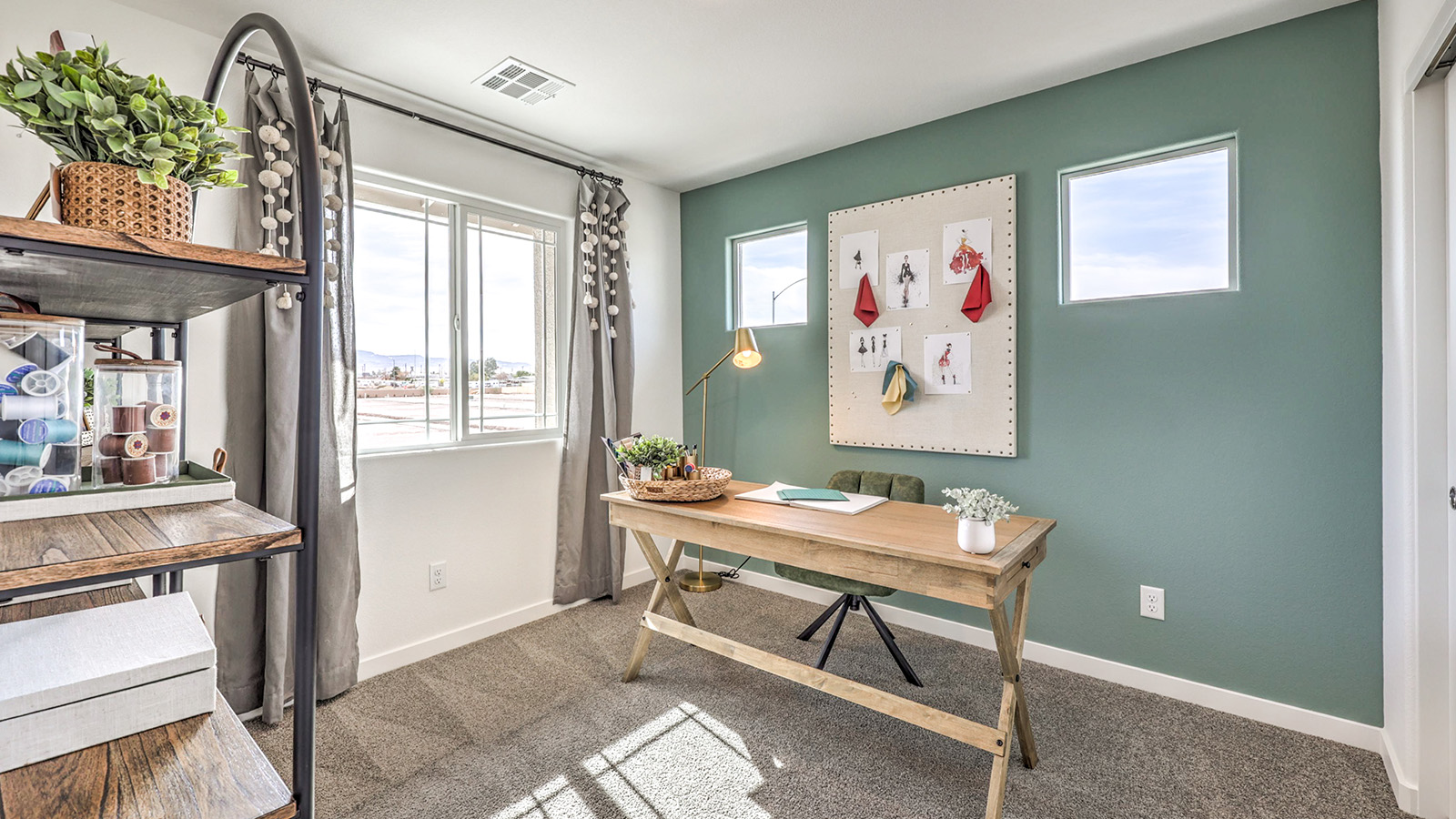 The Office/Bedroom Two option in our Symmetry Trails 1410 model with carpet flooring and a window, furnished a desk and chair.