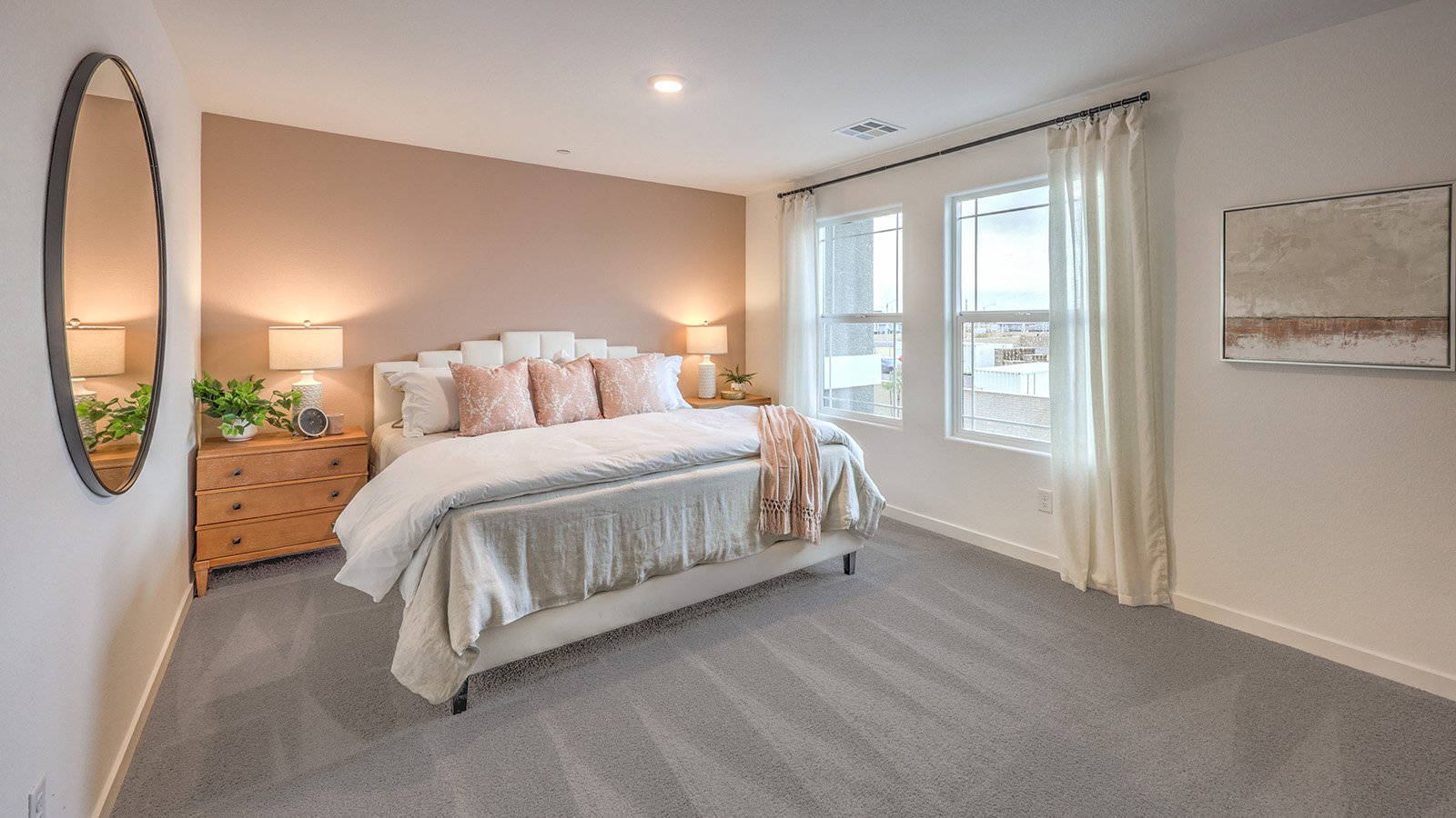 The Bedroom One Suite in our Alpine Trails  1309 model with carpet flooring, a walk-in closet, windows, and recessed ceiling lights.