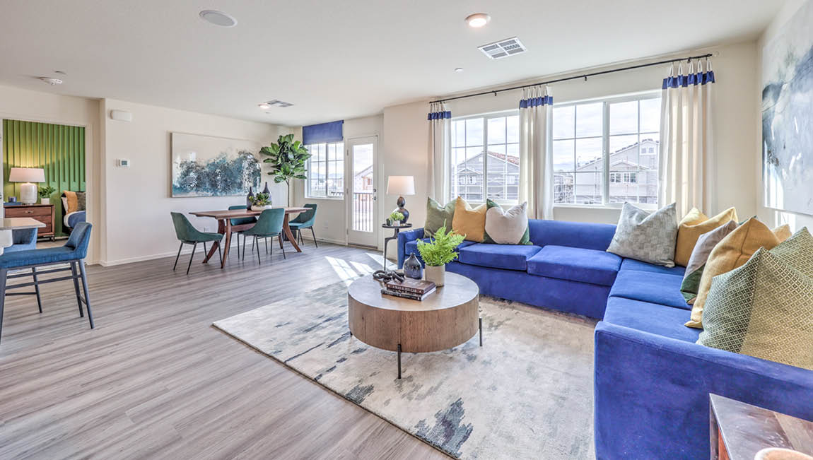 The Juno Pointe 1171 Plan open concept Great Room with LVP flooring and large windows.