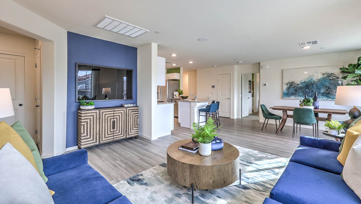 The Juno Pointe 1171 Plan open concept Great Room with LVP flooring and large windows.