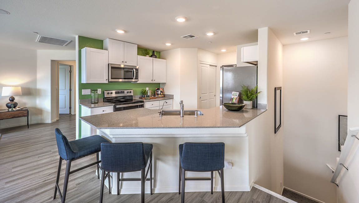 Our 1171 model kitchen in the Juno Pointe Community with a countertop seating area.