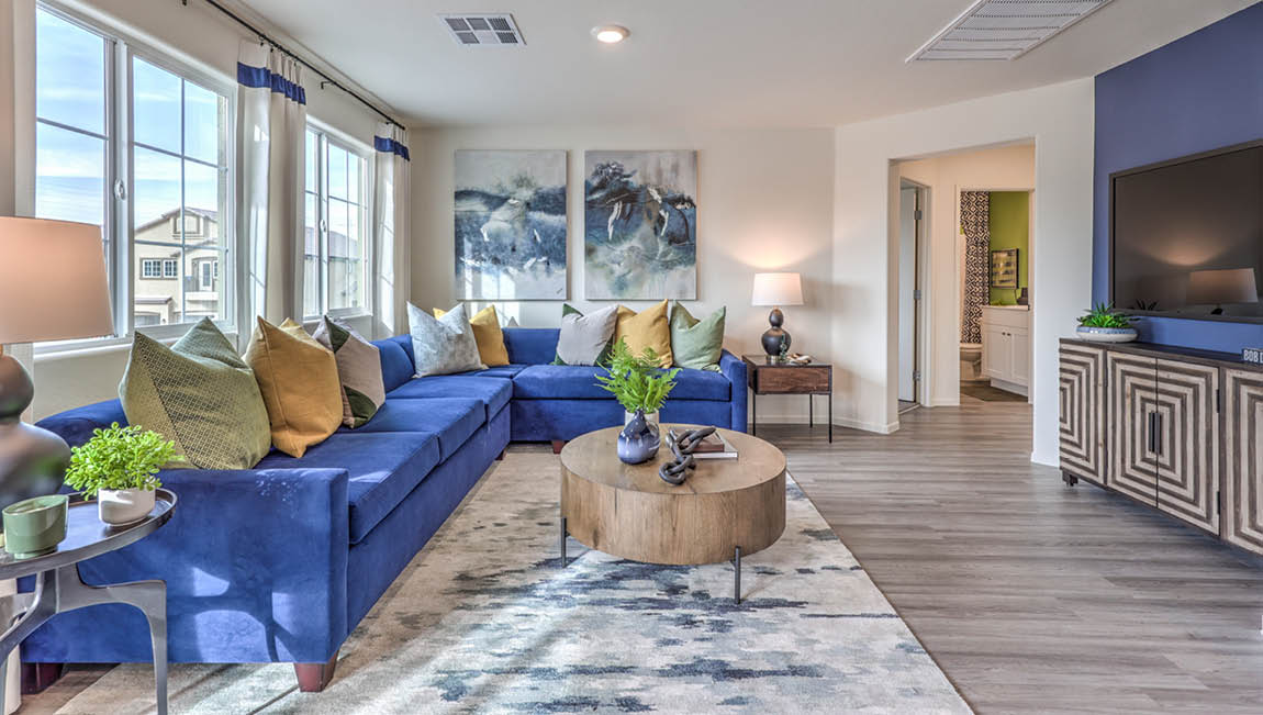 The Juno Pointe 1171 Plan open concept Great Room with LVP flooring and large windows.