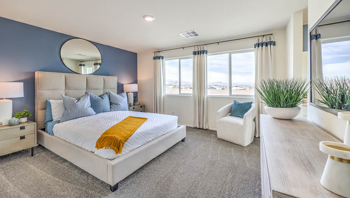 The Bedroom One Suite in our Juno Pointe 1349 model with carpet flooring, large windows, and recessed ceiling lights.