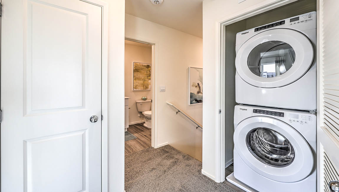 Our Juno Pointe 1349 model laundry room with a washer and dryer.