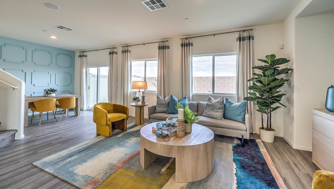 The Juno Pointe 1349 Plan open concept Great Room with LVP flooring and large windows.