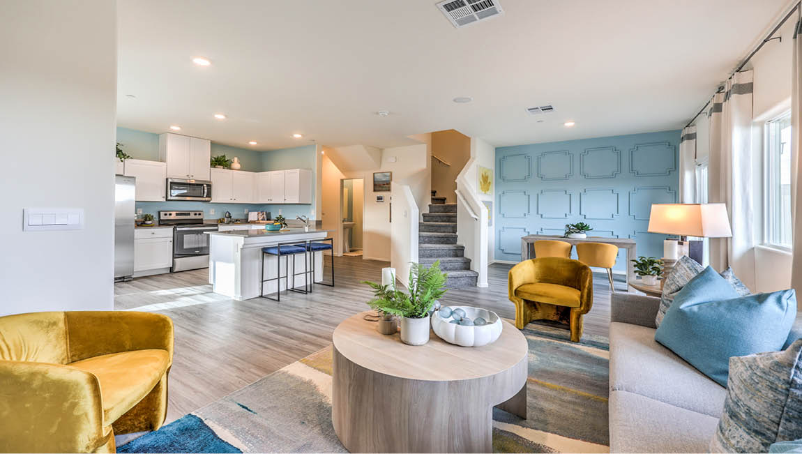 The Juno Pointe 1349 Plan open concept Great Room with LVP flooring and large windows.