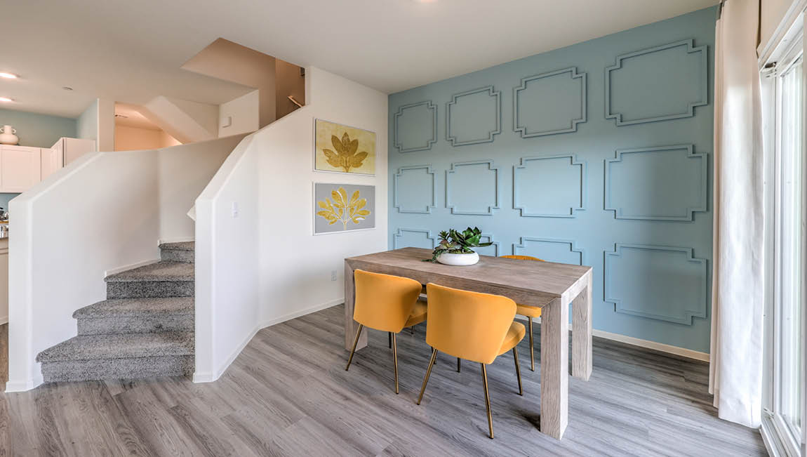 The Juno Pointe 1349 model Dining Room adjacent to the kitchen and great room with a table and window.