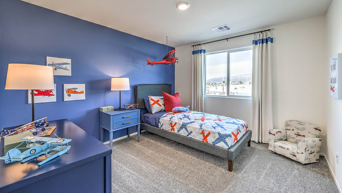 Bedroom Two in our Juno Pointe 1600 model with carpet flooring, a sliding closet, and a large window.