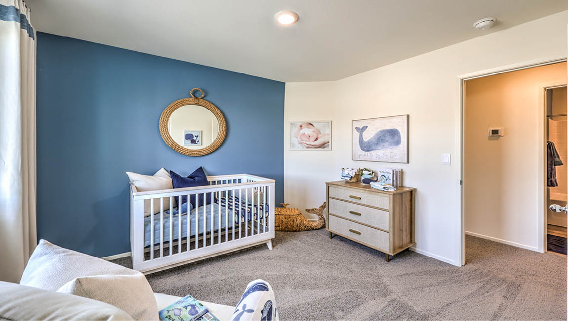Bedroom Three in our Juno Pointe 1600 model with carpet flooring, a sliding closet, and a large window.