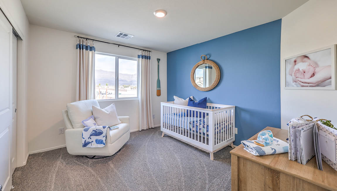 Bedroom Three in our Juno Pointe 1600 model with carpet flooring, a sliding closet, and a large window.
