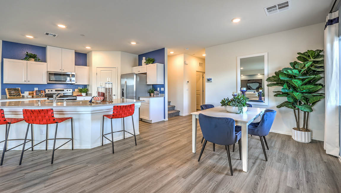 The Juno Pointe 1600 model Dining Room adjacent to the kitchen with a table and window.