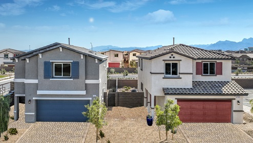 Exteriors in our Heartland Bay Community featuring front yard landscaping, paver driveways, and two-car garages.