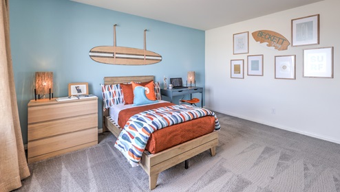 Bedroom Three in our Heartland Falls 3000 model with carpet flooring, a sliding closet, and a window.