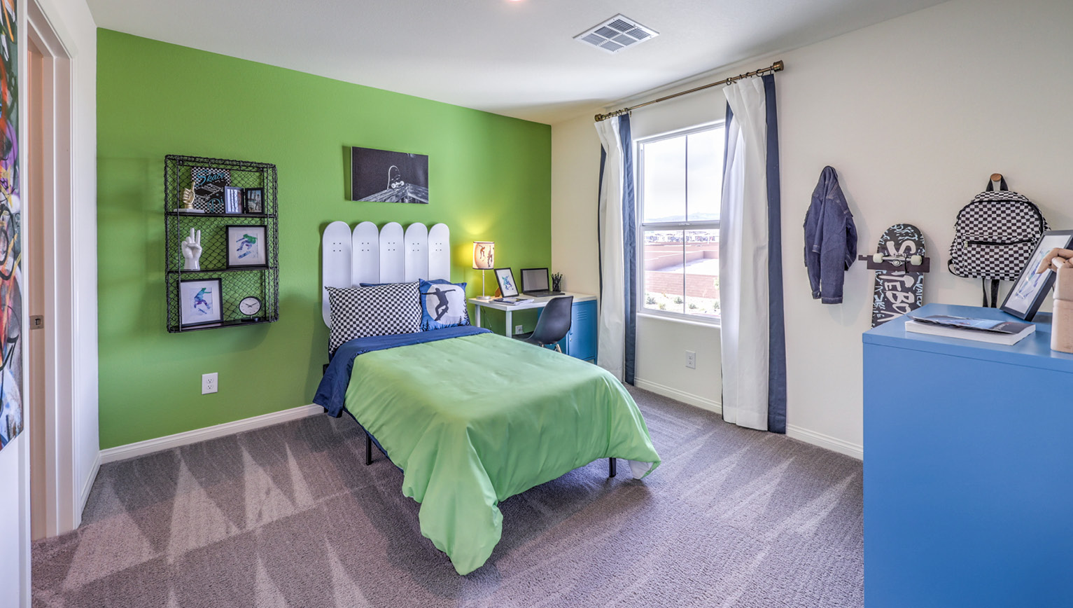 Bedroom Four in our Heartland Falls 2660 model with carpet flooring, a sliding closet, and a window.