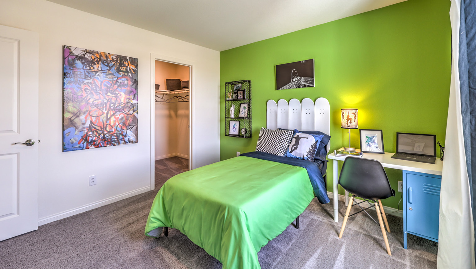 Bedroom Four in our Heartland Falls 2660 model with carpet flooring, a sliding closet, and a window.