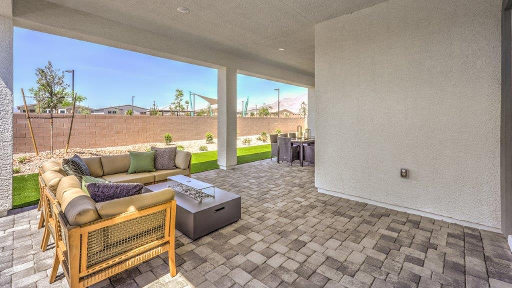 Our Heartland Summit 4418 model backyard with landscaping and a large covered patio.