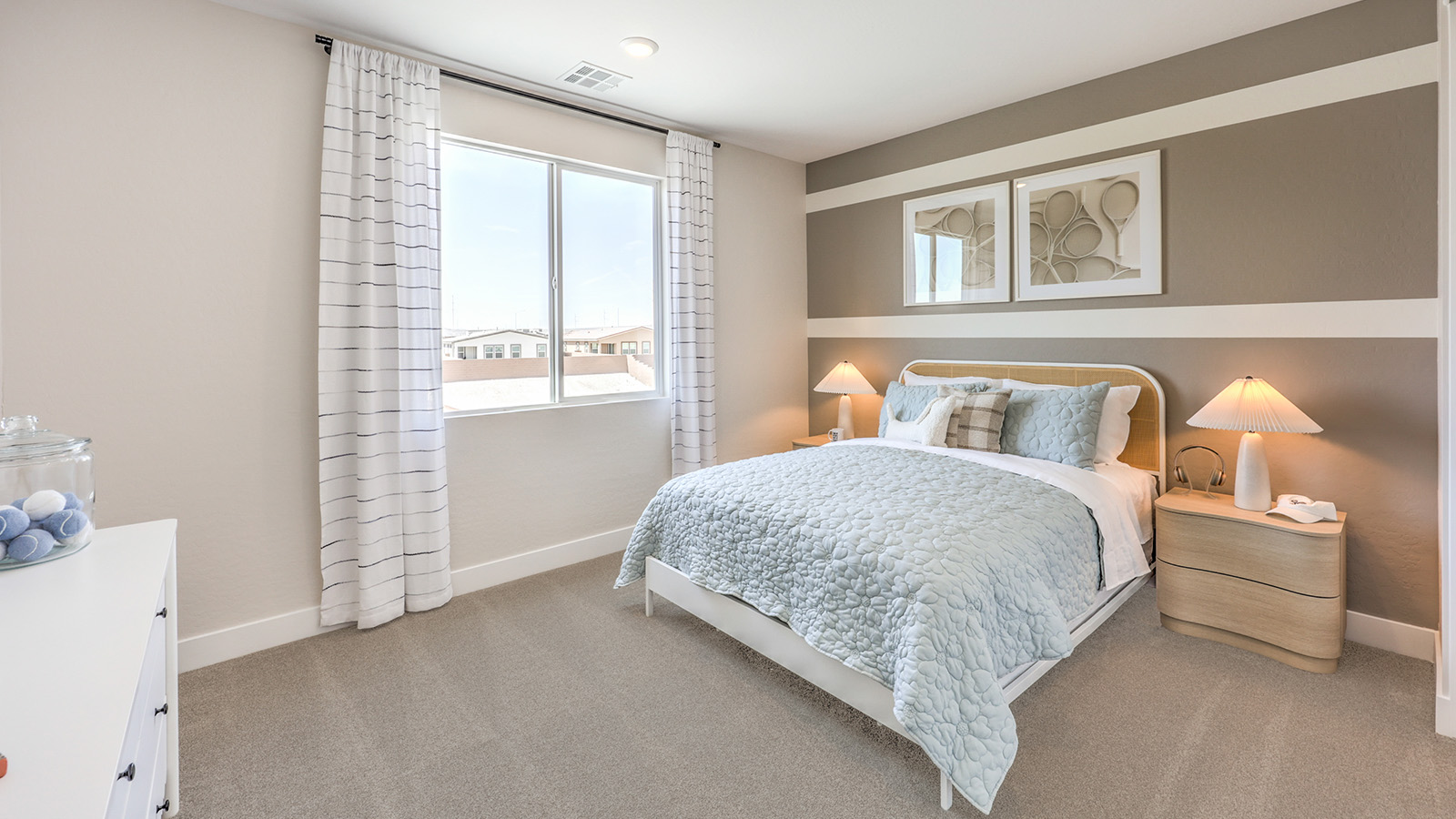 Bedroom Four in our Heartland Summit 3765 model with carpet flooring, a walk-in closet, and a window.