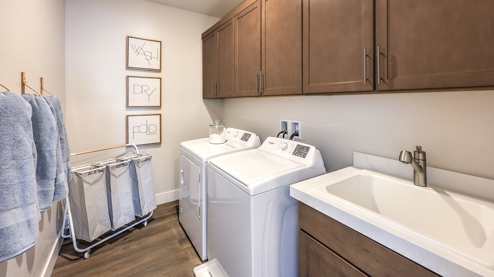 Our Heartland Summit 3765 model laundry room with cabinets and a washer and dryer.