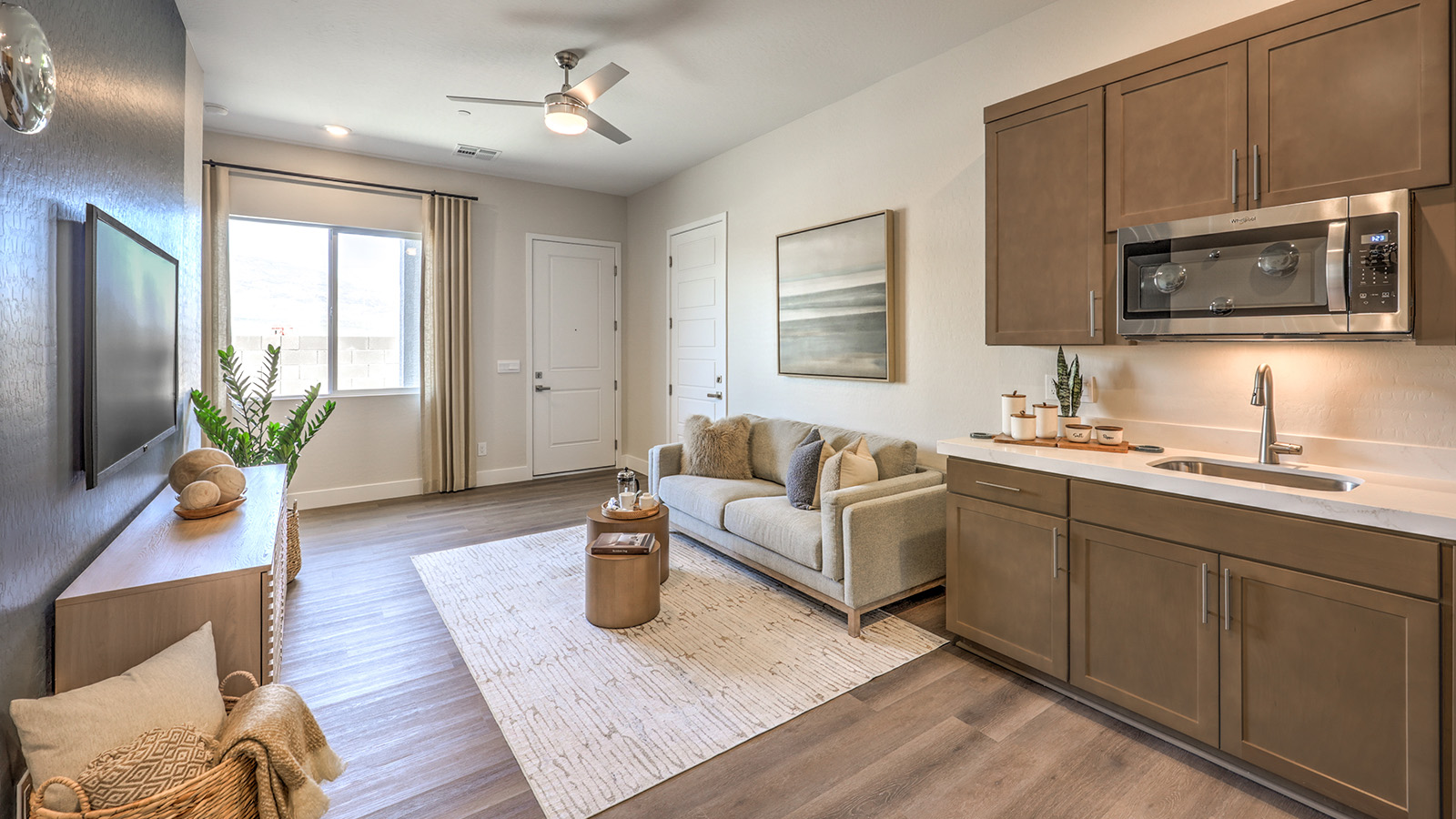 Our Heartland Summit 3765 Multigen with a Whirlpool stainless steel refrigerator, sink, shaker style cabinets, and granite countertops.