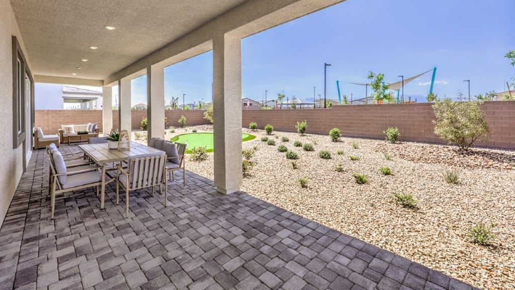 Our Heartland Summit 3765 model backyard with desert landscaping and a covered patio.