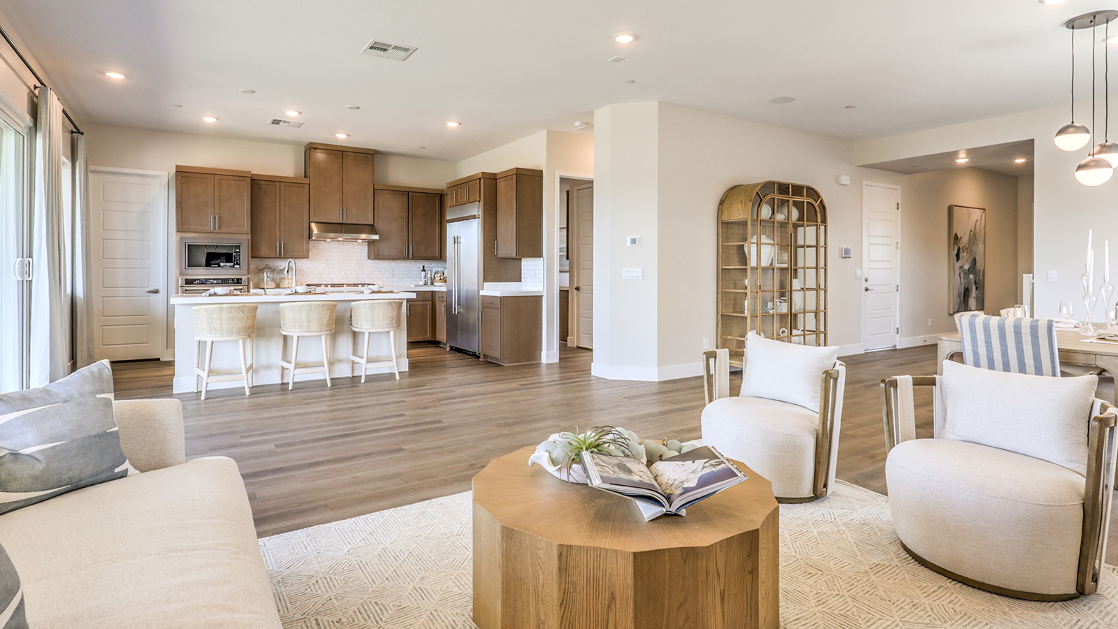 The Heartland Summit 3765 Plan open concept Great Room with ceramic tile flooring and large windows.