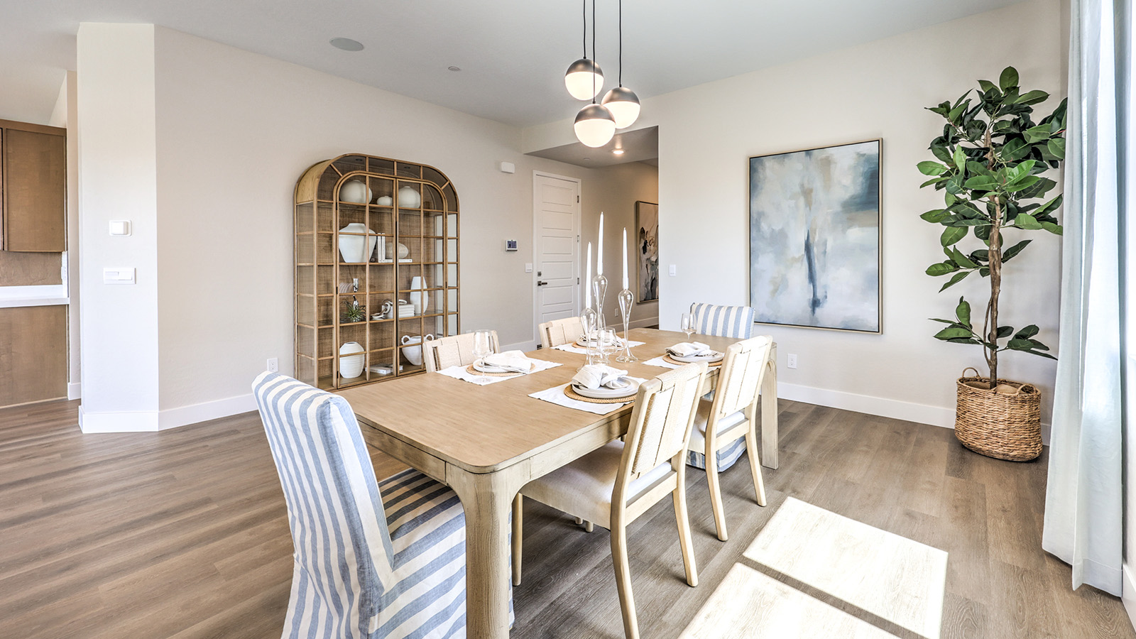 The Heartland Summit 3765 model Dining Room adjacent to the kitchen and great room with a table and large window.
