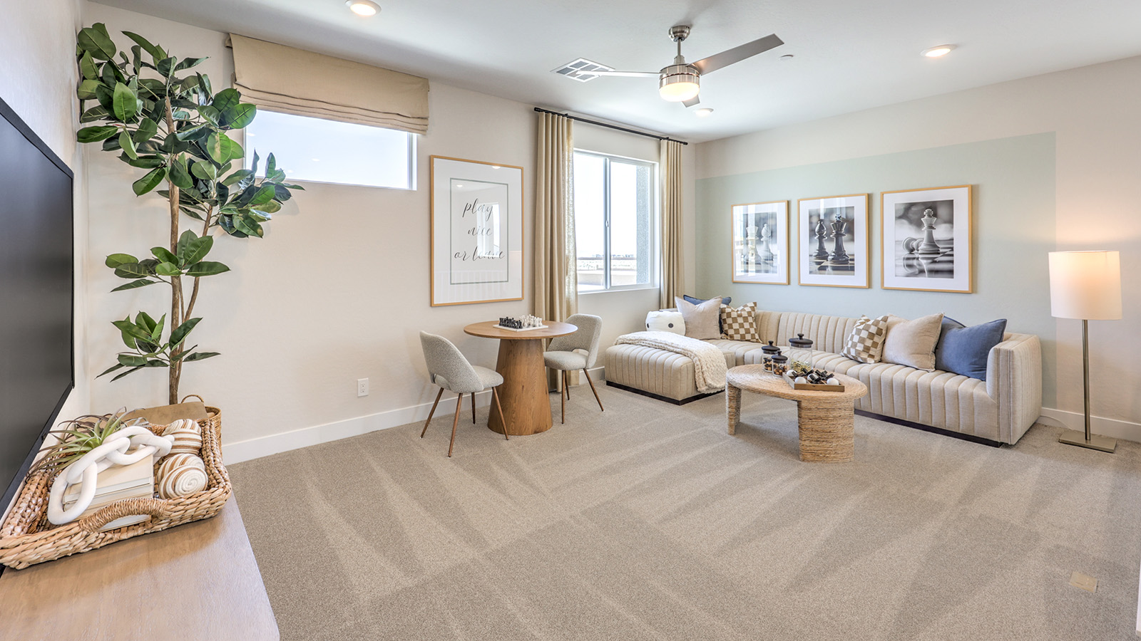 The upstairs loft in our 3765 model with carpet flooring and large windows.