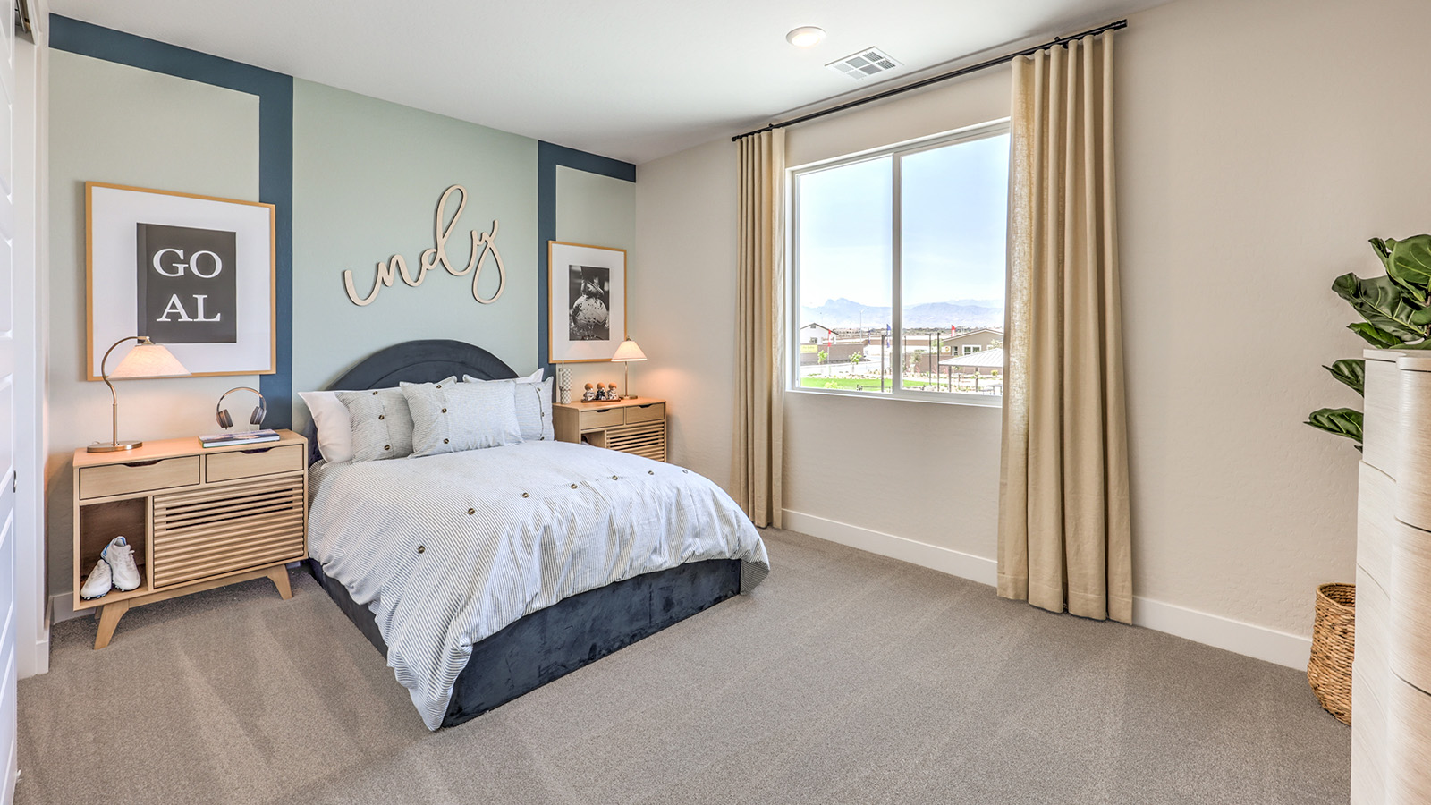 Bedroom Two in our Heartland Summit 3765 model with carpet flooring, a sliding closet, and a window.