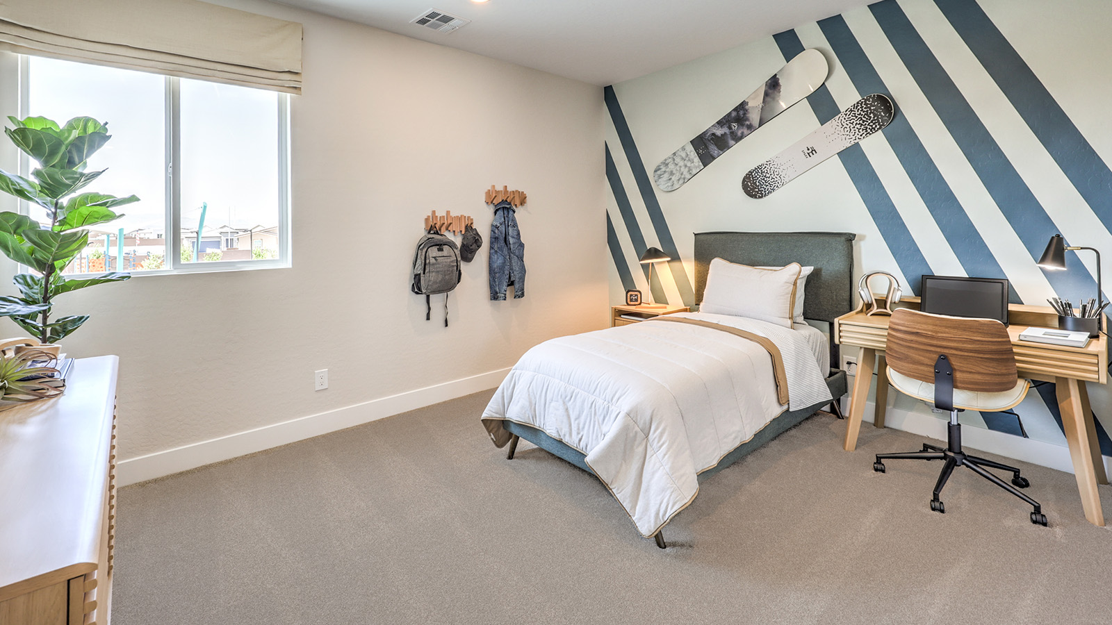 Bedroom Three in our Heartland Summit 3765 model with carpet flooring, a sliding closet, and a window.