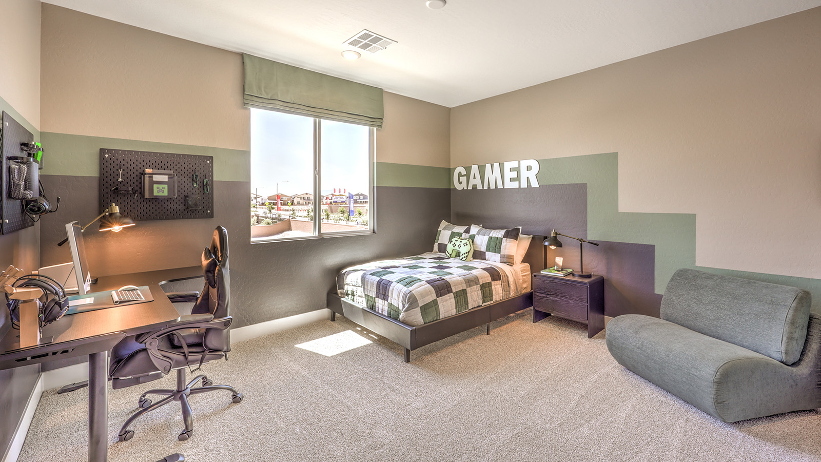 Bedroom Four in our Heartland Summit 4418 model with carpet flooring, a walk-in closet, and a window.