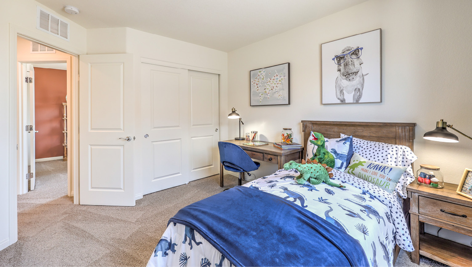 Bedroom Three in our Heartland Bay 1865 model with carpet flooring, a sliding closet, and one window.