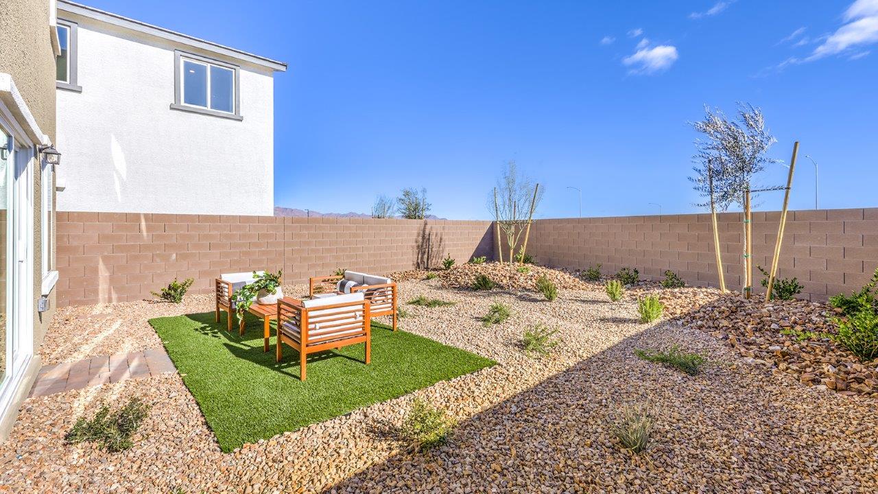 The backyard in our Heartland Bay 1802 plan with desert landscaping.