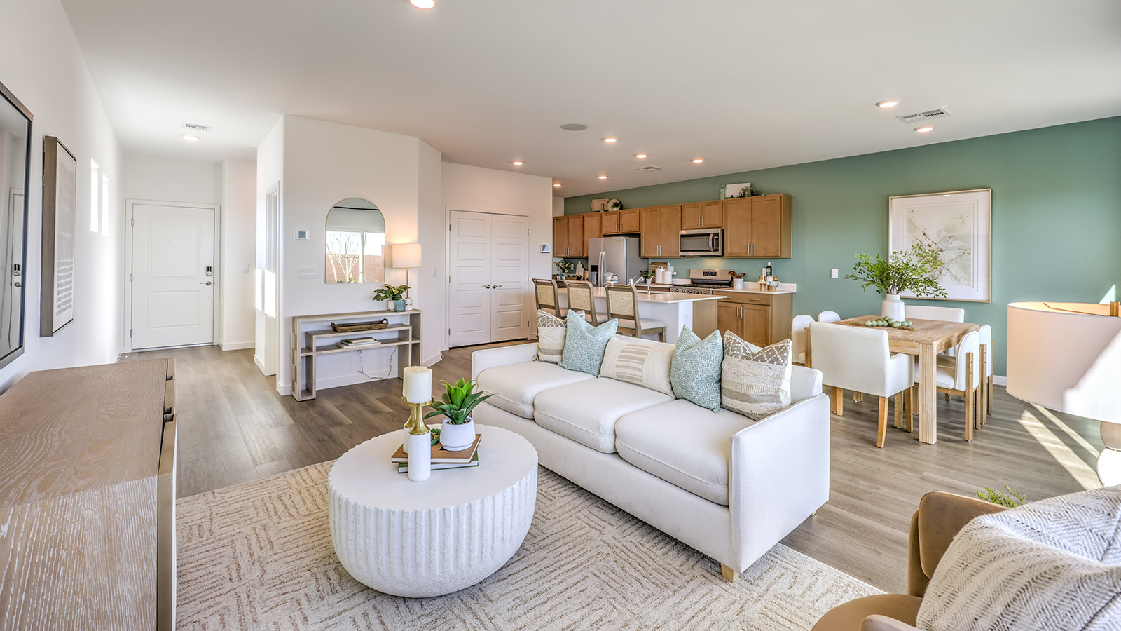 The Heartland Bay 1802 Plan open concept Great Room with LVP panel flooring and a sliding door to the backyard.