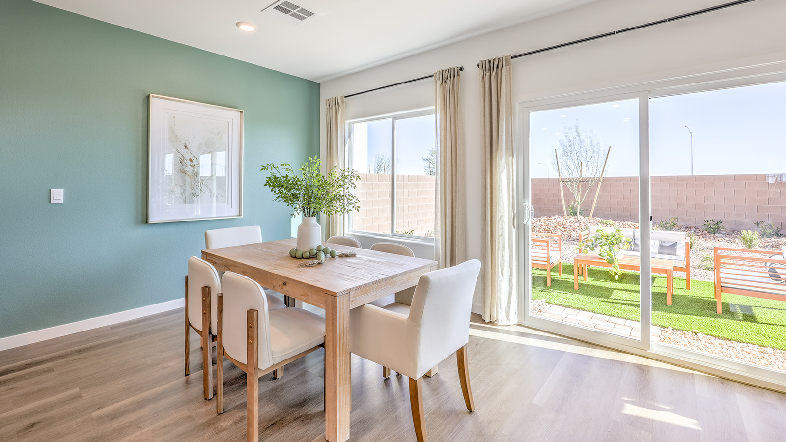 The Heartland Bay 1802 model Dining Room adjacent to the kitchen with a table and window.