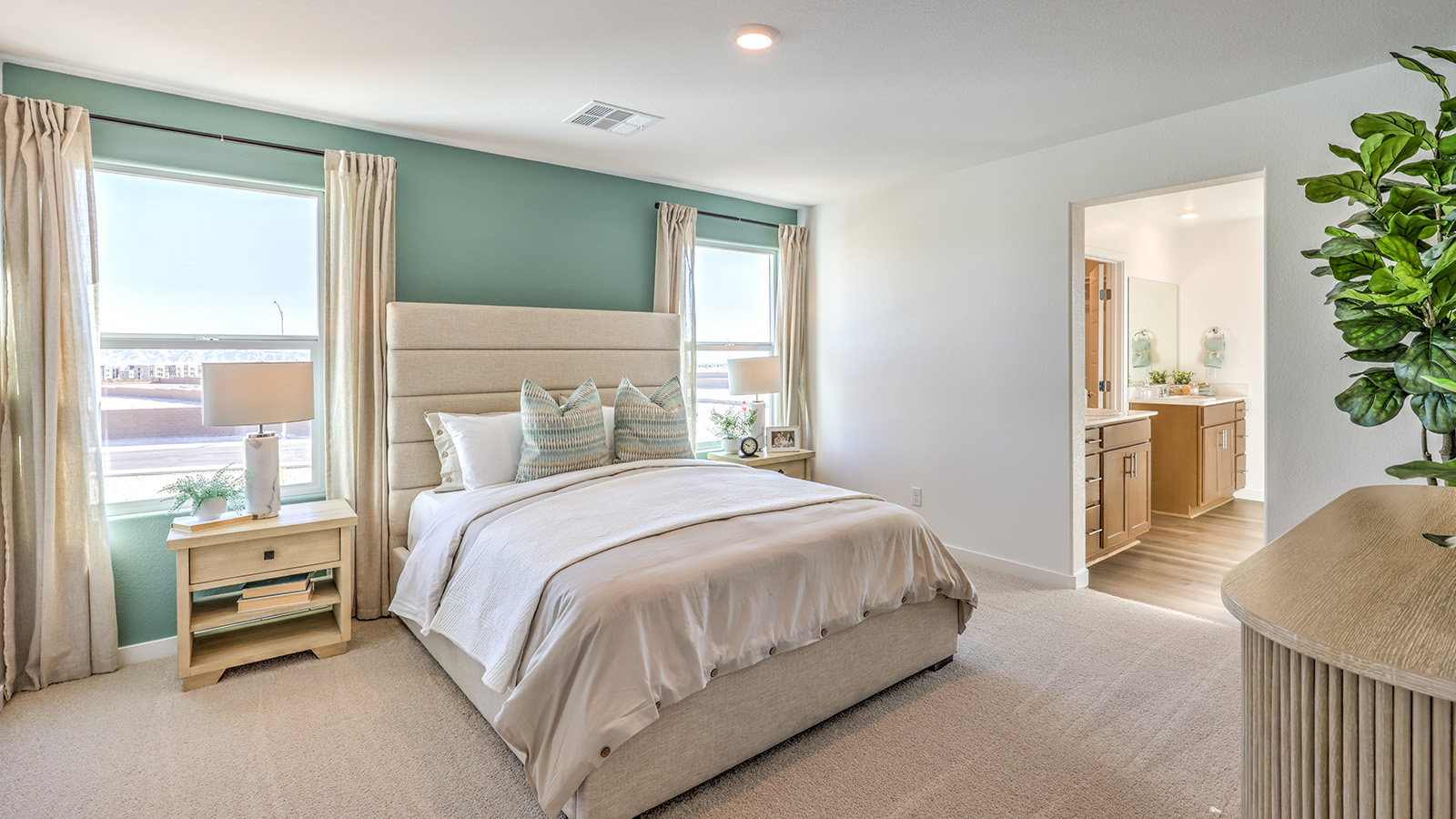 The Bedroom One Suite in our Heartland Bay 1802 model with carpet flooring and recessed ceiling lights.